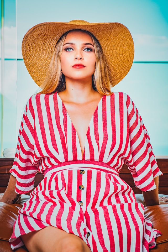 Portrait of woman in a sun hat and striped dress